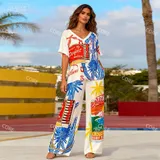 Completo con blusa e pantaloni stampati — foto 1